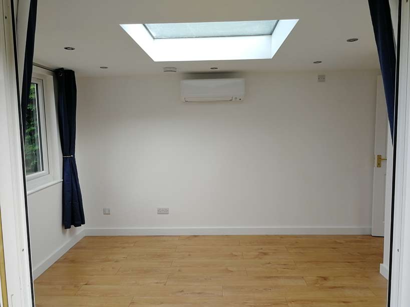 Inside the wooden annex, you choose the interior look and feel, with plastered walls and laminated floor options. Showing air con / heat pump for heating and cooliong