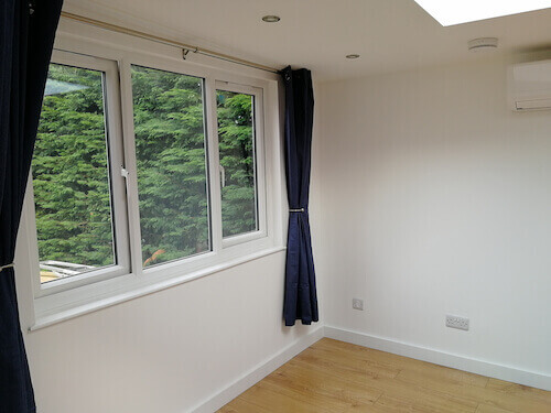 The interior of a finished office annexe showing glass double windows.